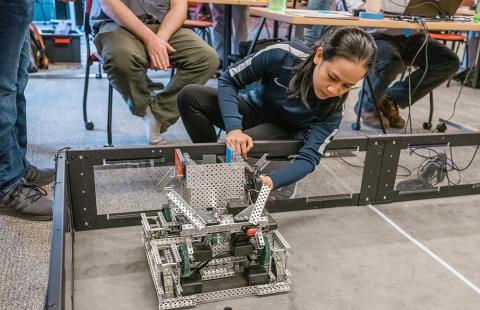 UNH Manchester mechanical engineering technology student Anh Nguyen working on a robot