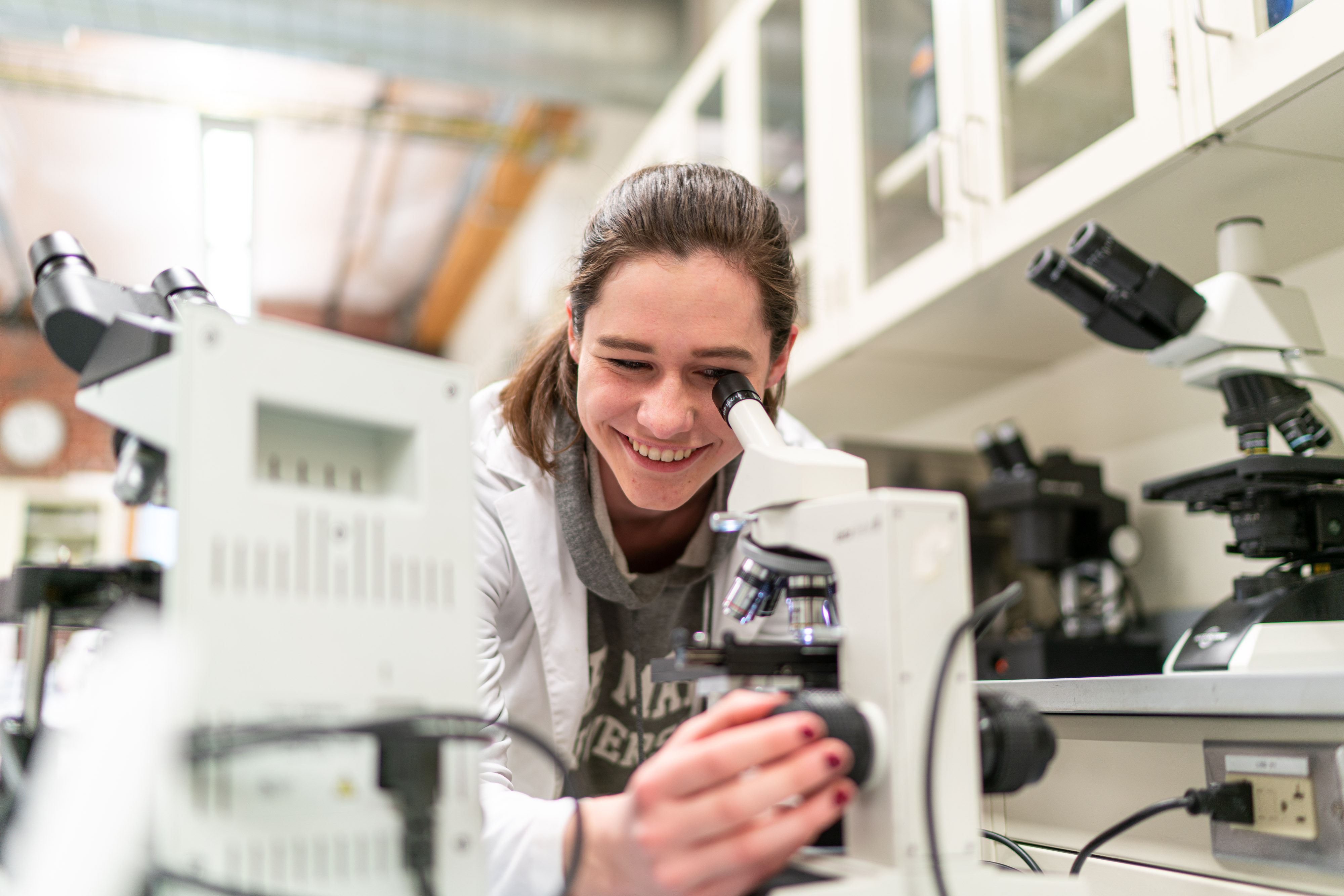 student at microscope