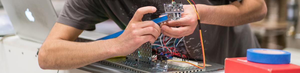 Student connecting electrical circuitry in control systems and components class