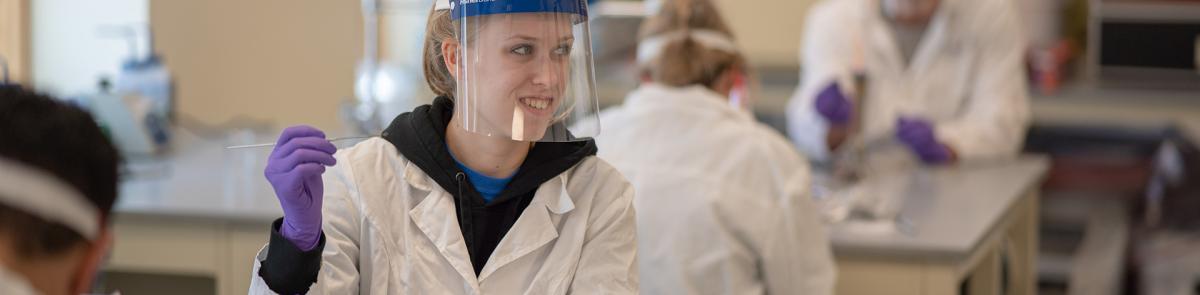 A biotechnology master's degree student working in a lab.