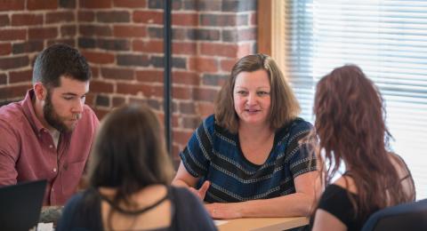 Dr. Alison Paglia works with students in her Research Methods in Psychology course.