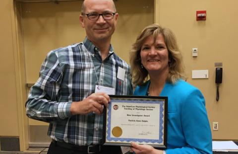 Assistant Professor Patricia Halpin, right, receiving the 2017 New Investigator Award from the American Physiological Society