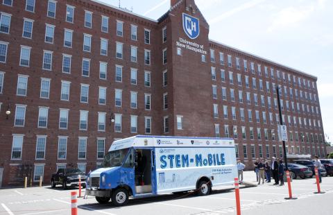 The STEM-MoBILE from the outside with UNH Manchester in the background.
