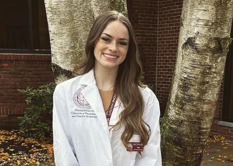 UNH Manchester neuropsychology graduate Tristen Witkowski '22 poses in her lab coat from MCPHS University