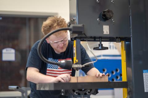 UNH Manchester student fabricates a guitar in the machine shop