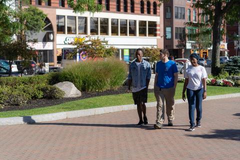 three students walking downtown manchester