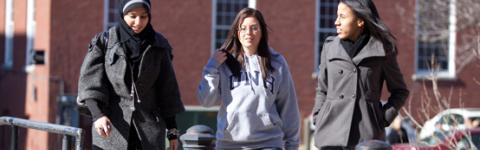 Three students walking outside on campus