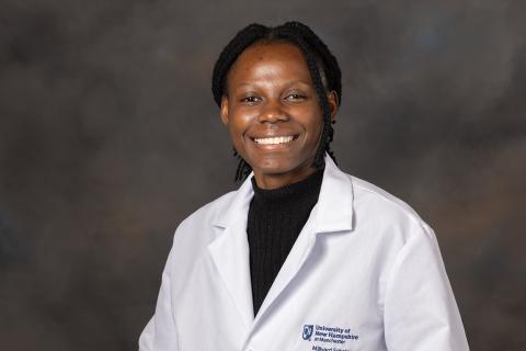 Headshot of UNH Manchester biotechnology major Annie Katanga '26 in her lab coat