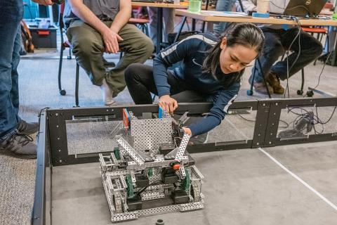 UNH Manchester mechanical engineering technology student Anh Nguyen working on a robot