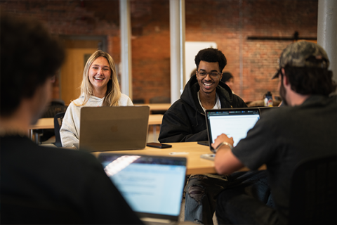 students at computers smiling