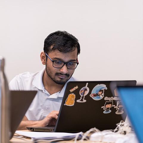 gradate student sitting at a computer 