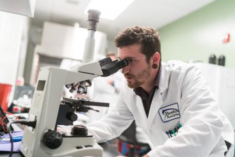 Man looking into microscope