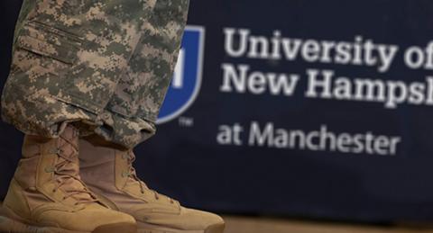 Military camo legs and boots and UNHM sign