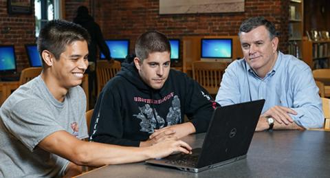 Students and advisor at computer